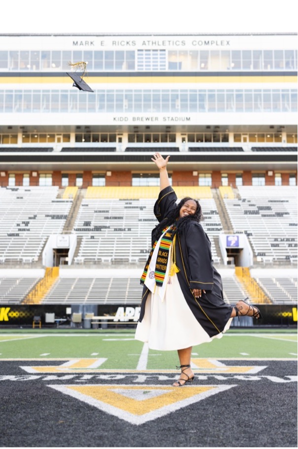 Photo above features Ryan Stukes tossing her cap and gown for graduation photos, May 2025. Photo submitted.