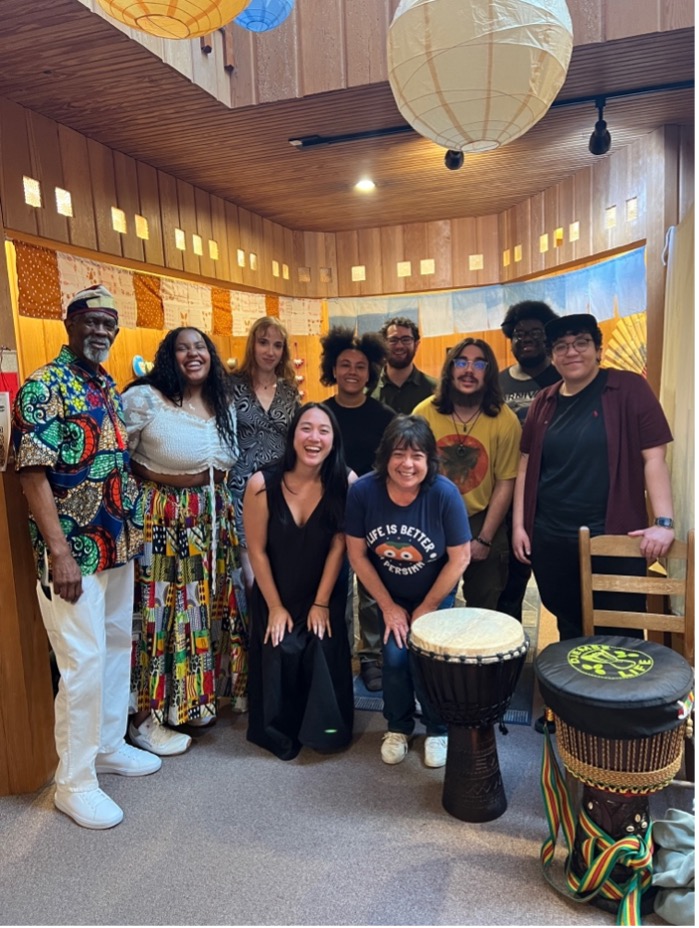 In above photo, Ryan Stukes and community members pose in The Happy Persimmon during her thesis research in 2025. Photo submitted