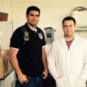 Here DJ (right) is shown in his lab coat with graduate student and lab mentor Oscar (left).