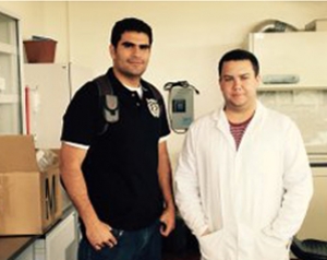 Here DJ (right) is shown in his lab coat with graduate student and lab mentor Oscar (left).