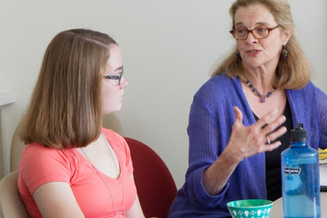 A student engaged in a discussion with a faculty member.