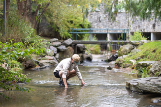 Student conducting research in creek