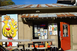The photo features the mural and the outside view of Crop & Trade Co-Op.