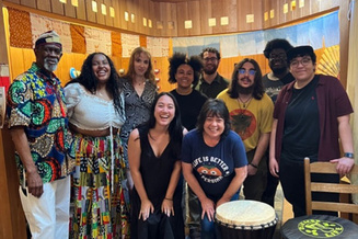 Ryan Stukes and community members pose in The Happy Persimmon during her thesis research in 2025. 