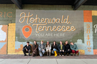 App State ASE volunteers pose in front of the Hohenwald, Tennessee, welcome sign.