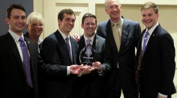 Honors Senior Alum Eric Vickers (shown center holding trophy), along with three other Risk Management and Insurance (RMI) majors from Appalachian State University